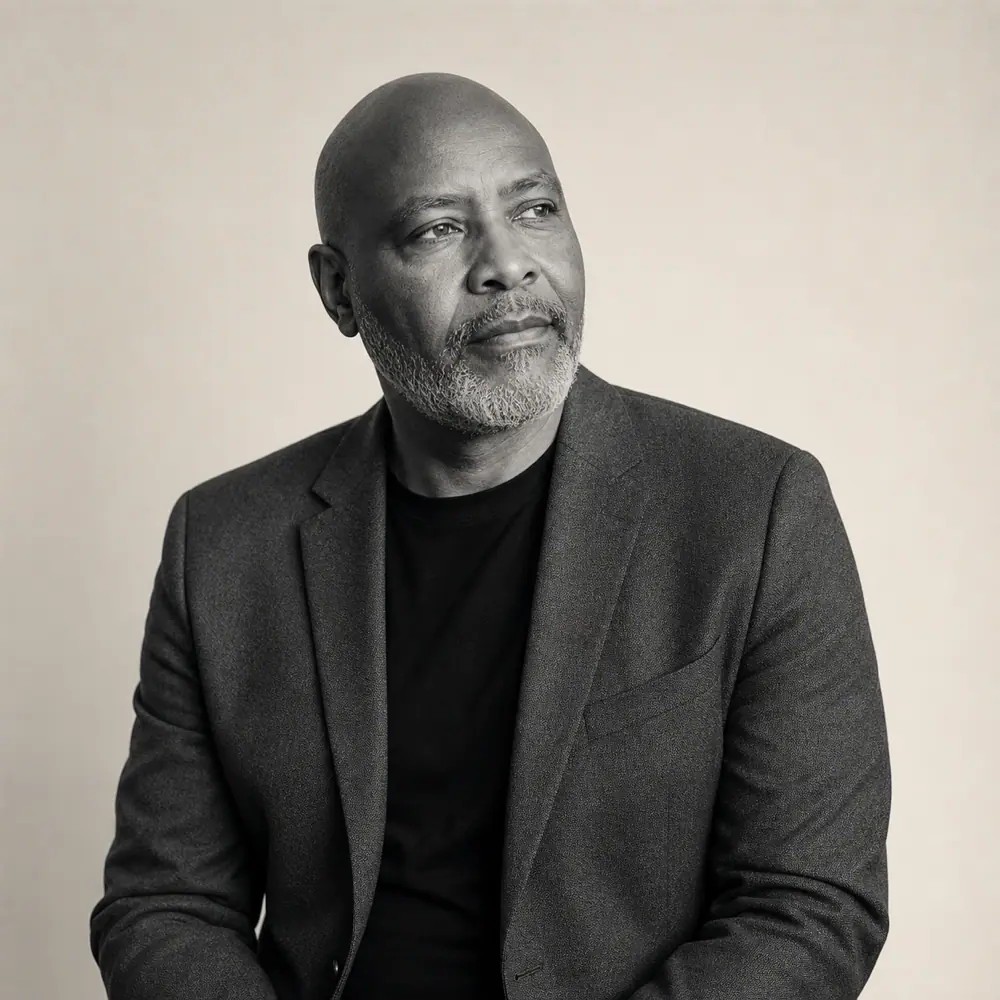 Black-and-white studio portrait of a business leader looking thoughtfully to one side